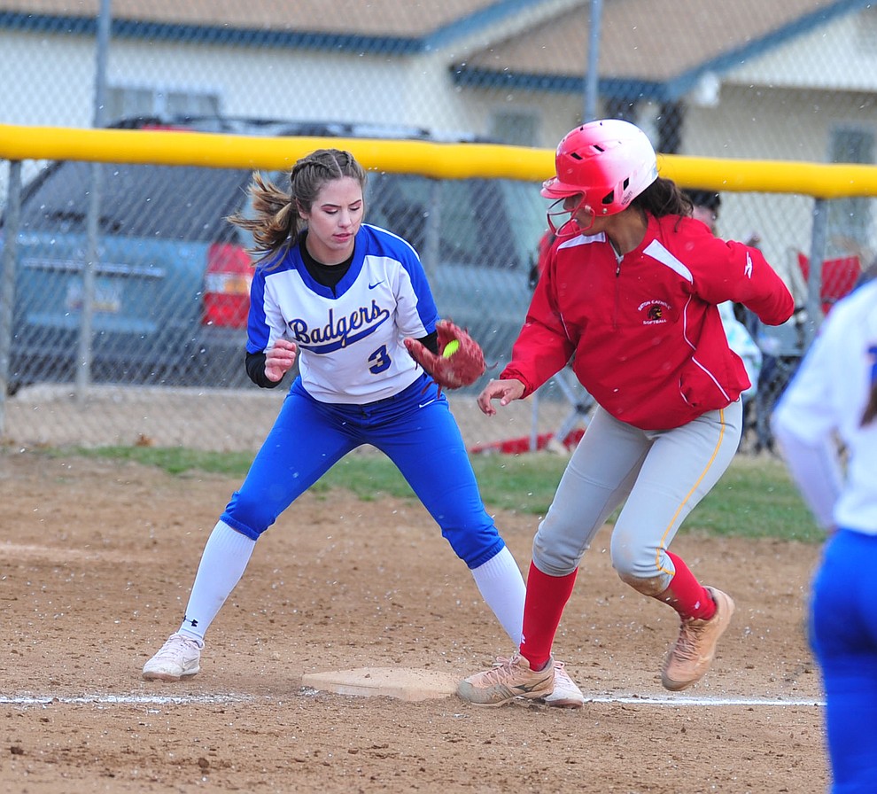Prescott's Morgan Little tries to get the out at third as the Badgers host Seton Catholic on a blustery day Friday, March 8, 2019. Les Stukenberg/Courier)