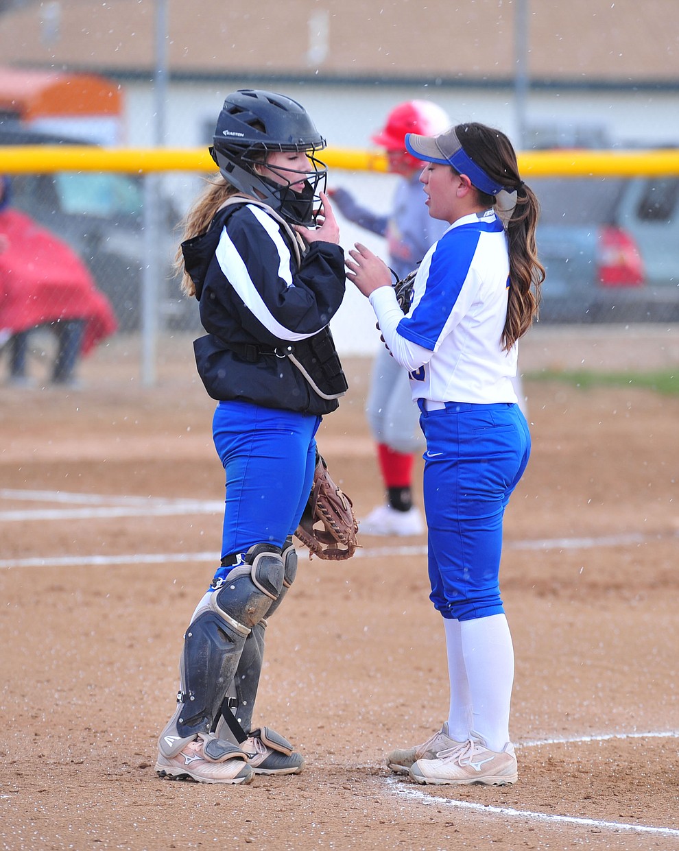 Prescott's Danner Cozens and Makayla Reyes talk on the mound after giving up a homer as the Badgers host Seton Catholic on a blustery day Friday, March 8, 2019. Les Stukenberg/Courier)