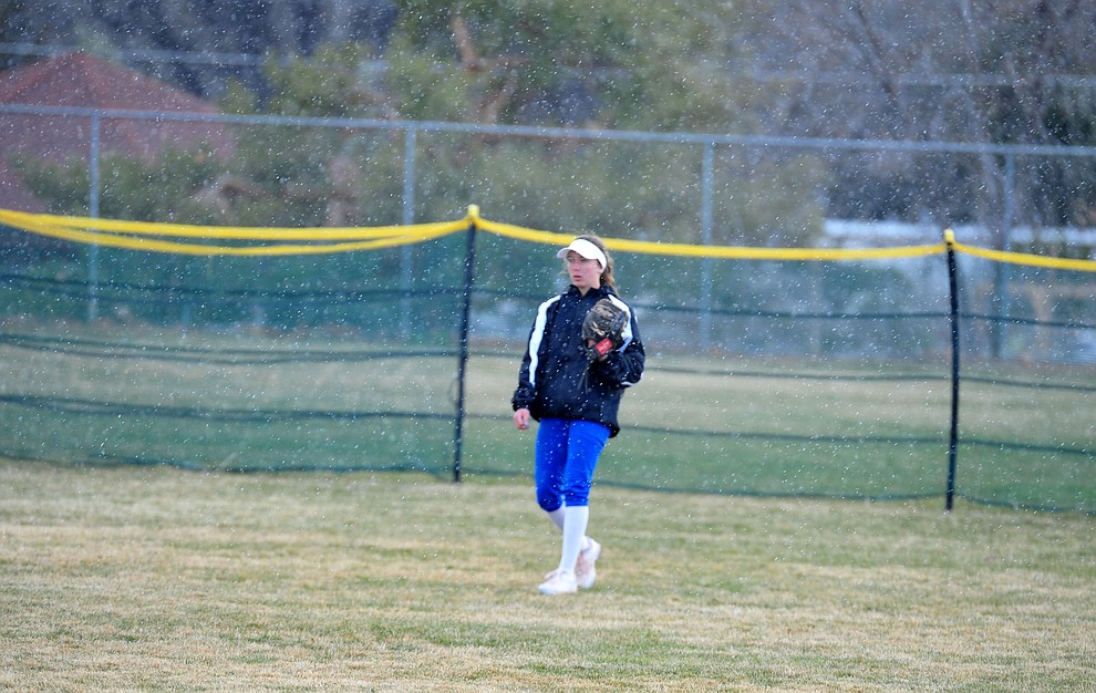 Prescott center fielder Dana Seavey stands in the freezing rain as the Badgers host Seton Catholic on a blustery day Friday, March 8, 2019. Les Stukenberg/Courier)