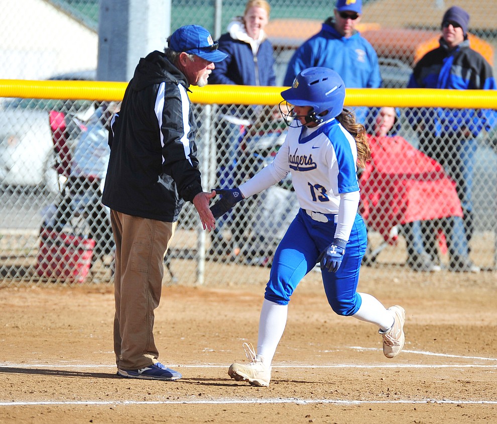 Prescott's Makayla Reyes gets congratulated by head coach Randall Bryan after hitting a solo home run in the first inning as the Badgers host Seton Catholic on a blustery day Friday, March 8, 2019. Les Stukenberg/Courier)