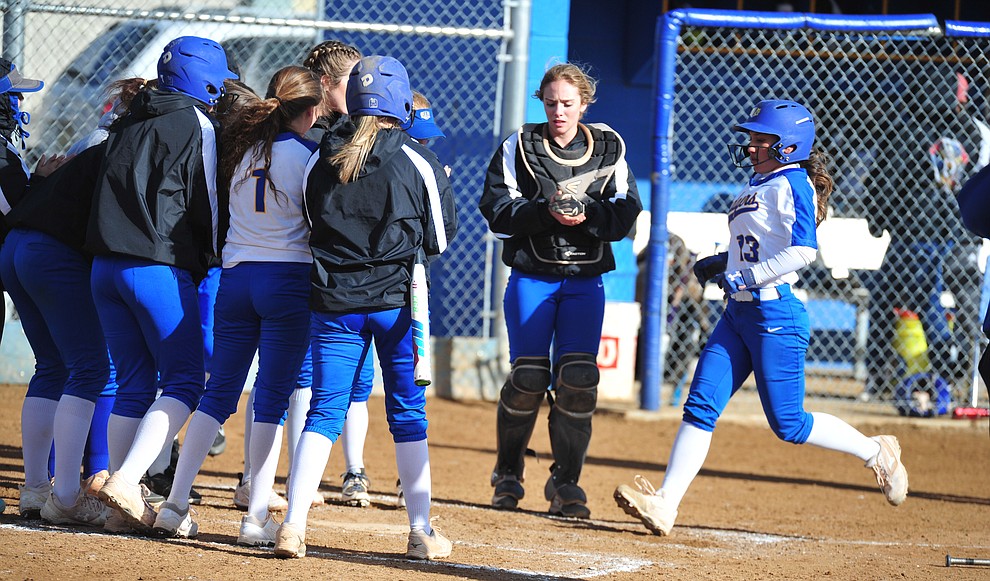 Prescott's Makayla Reyes gets congratulated by her teammates after hitting a solo home run in the first inning as the Badgers host Seton Catholic on a blustery day Friday, March 8, 2019. Les Stukenberg/Courier)