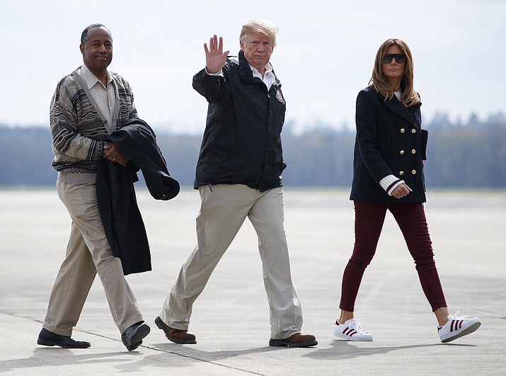 President Donald Trump, first lady Melania Trump and Secretary of Housing and Urban Development Ben Carson walk from Marine One to board Air Force One at Lawson Army Airfield, Fort Benning, Ga., Friday, March 8, 2019, en route Palm Beach International Airport in West Palm Beach, Fla., after visiting Lee County, Ala., where tornadoes killed 23 people. (Carolyn Kaster/AP)