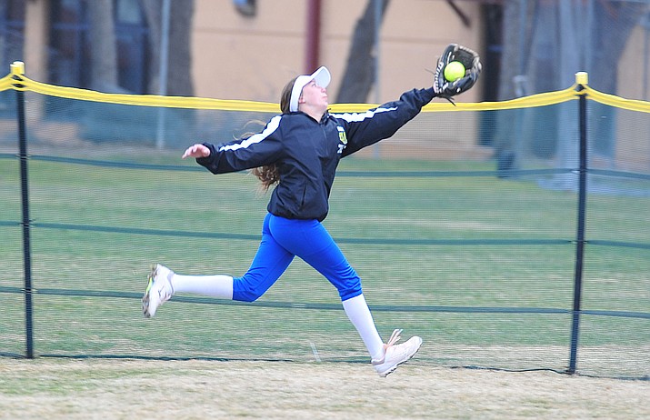 Prescott’s Dana Seavey makes a running grab in center field as the Badgers host Seton Catholic on a blustery day Friday, March 8, 2019. Les Stukenberg/Courier)