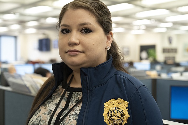 In this Feb. 11, 2019 photo, Rebecca Shutt, who works in the New York Police Department's Office of Crime Control Strategies, poses for a photo in New York. Shutt utilizes a software called Patternizr, which allows crime analysts to compare robbery, larceny and theft incidents to the millions of crimes logged in the NYPD's database, aiding their hunt for crime patterns. It's much faster than the old method, which involved analysts sifting through reports and racking their brains for similar incidents. (AP Photo/Mark Lennihan)