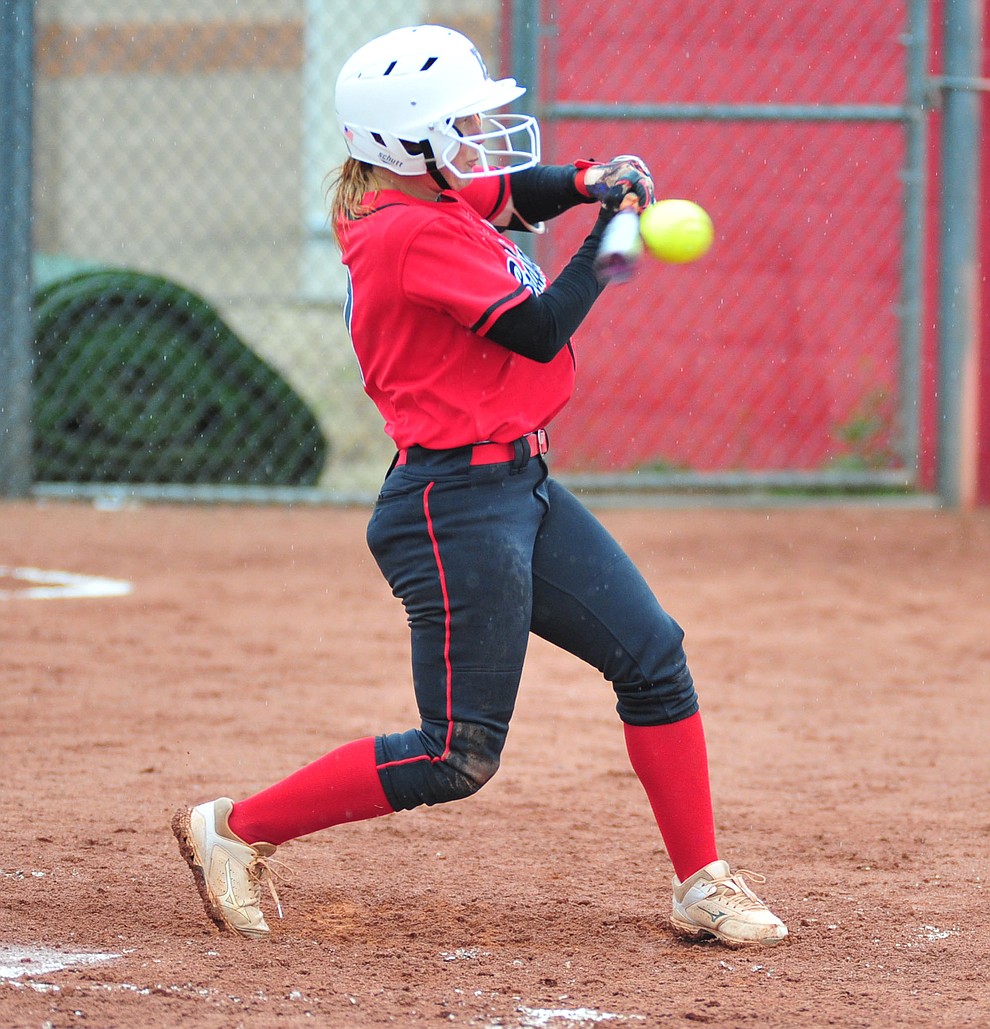 Bradshaw Mountain's Shelby Dilcher makes contact as the Bears take on Coconino in a steady rainfall, Monday, March 11, 2019, in Prescott Valley. Les Stukenberg/Courier)
