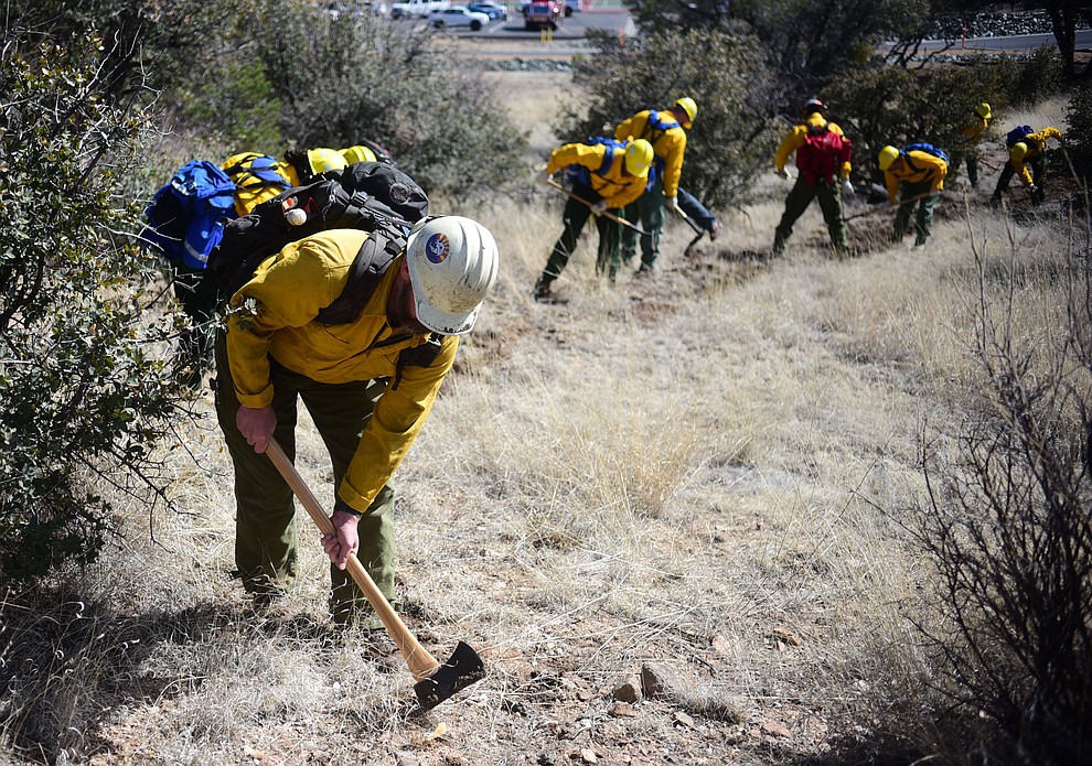 Arizona Wildfire & Incident Management Academy's 92 students in four S130/190 Basic Wildland Firefighting classes cut line while out on their field day at Embry Riddle Aeronatical University, Wednesday, March 13, 2019, in Prescott. (Les Stukenberg/Courier)