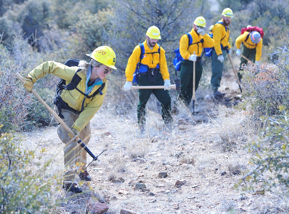 Arizona Wildfire & Incident Management Academy's 92 students in four S130/190 Basic Wildland Firefighting classes cut line while out on their field day at Embry Riddle Aeronatical University, Wednesday, March 13, 2019, in Prescott. (Les Stukenberg/Courier)