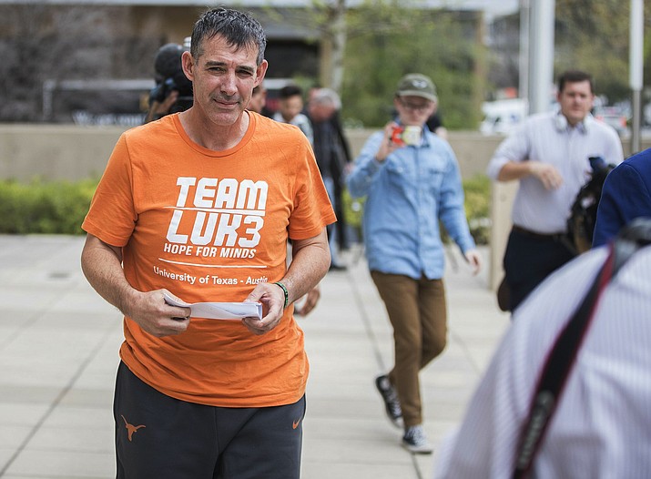 Texas men’s tennis coach Michael Center walks away from the Federal Courthouse in Austin, Texas, Tuesday, March 12, 2019. Center is among a few people in the state charged in a scheme that involved wealthy parents bribing college coaches. (Ricardo B. Brazziell/AP)