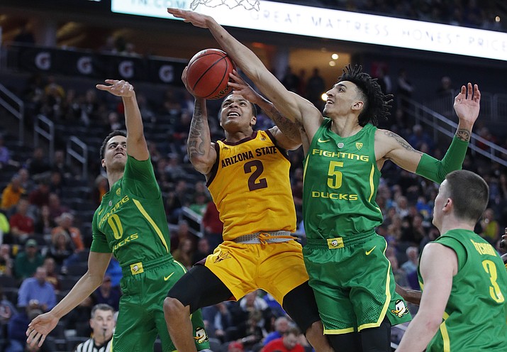 Arizona State's Rob Edwards (2) tries to shoot around Oregon's Will Richardson, left, and Oregon's Miles Norris during the first half of an NCAA college basketball game in the semifinals of the Pac-12 men's tournament Friday, March 15, 2019, in Las Vegas. (John Locher/AP)