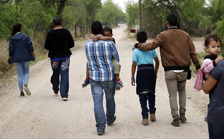 A group of migrant families walks Thursday, March 14, 2019, from the Rio Grande, the river separating the U.S. and Mexico in Texas, near McAllen, Texas. The migrants said they crossed the river in an inflatable raft and were hoping to be apprehended by the Border Patrol so they could be processed and released. (Eric Gay/AP)