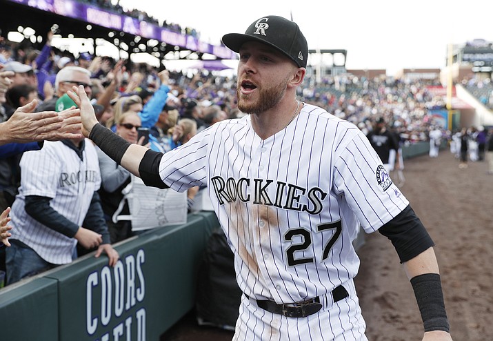 In this Sept. 30, 2018, file photo, Colorado Rockies shortstop Trevor Story is congratulated by fans after the ninth inning of a baseball game against the Washington Nationals in Denver. (David Zalubowski/AP, file)
