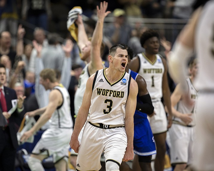 Wofford guard Fletcher Magee (3) celebrates with teammates after hitting a 3-point basket during the final moments of the second half against Seton Hall in a first-round game in the NCAA men’s college basketball tournament in Jacksonville, Fla. Thursday, March 21, 2019. (Stephen B. Morton/AP)