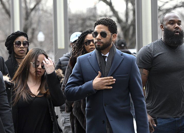 Empire actor Jussie Smollett, center, arrives at the Leighton Criminal Court Building for his hearing on Thursday, March 14, 2019, in Chicago. Smollett is accused of lying to police about being the victim of a racist and homophobic attack by two men on Jan. 29 in downtown Chicago. (Matt Marton/AP)