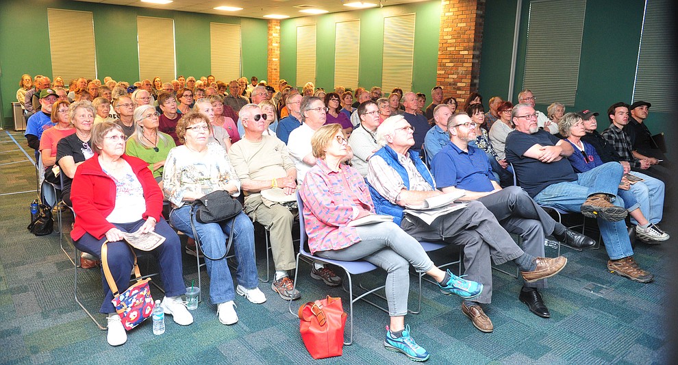 Approximately 110 people got over seats at the Prescott Public Library, the council chambers were filled and 60 still waiting the hallway and several hundred Save the Dells supporters gathered outside Prescott City Hall to show their support against the planned Arizona Eco Development and annexation of some of the Granite Dells area Tuesday, March 26 in Prescott. (Les Stukenberg/Courier)