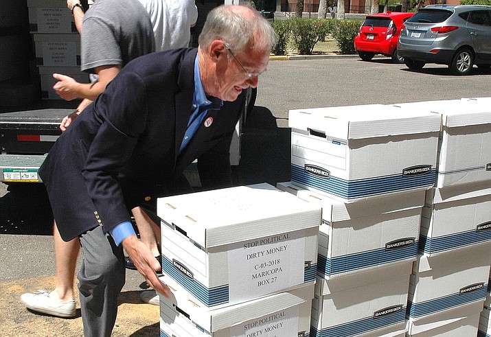 Former Attorney General Terry Goddard unloads boxes of petitions in 2018 for to put a financial disclosure requirement into the Arizona Constitution. Backers of a bid to ask voters to outlaw title loans have quit amid the inability to raise the cash they need to get it -- and keep it -- on the November ballot. (Capitol Media Services file photo by Howard Fischer)