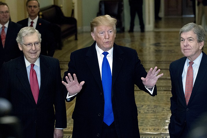 President Donald Trump accompanied by Senate Majority Leader Mitch McConnell of Ky., left, and Sen. Roy Blunt, R-Mo., right, arrives for a Senate Republican policy lunch on Capitol Hill in Washington, Tuesday, March 26, 2019. (Jose Luis Magana/AP)
