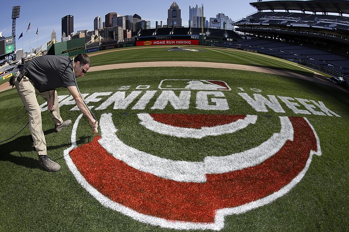 Andy Burnette, of the PNC Ground Crew paints, the Opening Week logo on the field at PNC Park Wednesday, March 27, 2019 in preparation for the Pittsburgh Pirates home-opener on Monday, April 1, against the St. Louis Cardinals. (Gene J. Puskar/AP)