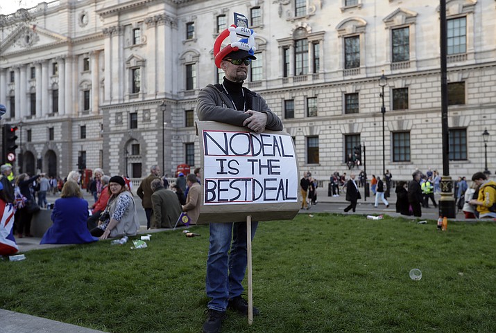 A Brexit supporter holds a sign during a rally after the final leg of the "March to Leave" in London, Friday, March 29, 2019. Pro-Brexit demonstrators were gathering in central London on the day that Britain was originally scheduled to leave the European Union. (Kirsty Wigglesworth/AP)