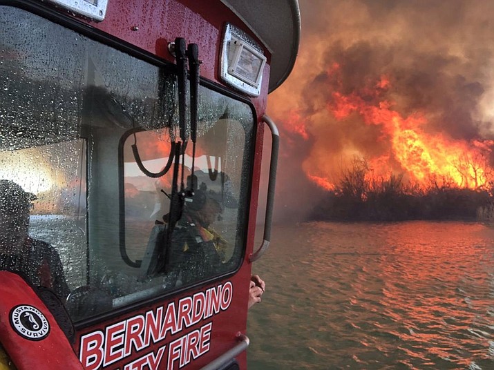 A San Bernardino County Fire Department boat gets closer to a fire near State Route 95 in Lake Havasu City, which remains closed in both directions as fire crews fight the Body Beach Fire. (San Bernardino County Fire Department, via Today's News-Herald/Courtesy)