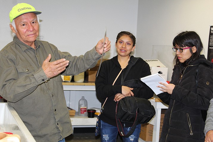 NAU photography professor Sam Minkler gives photo tips to Hopi High media students Kimmale Anderson and Cierra Brady. (Stan Bindell/NHO)
