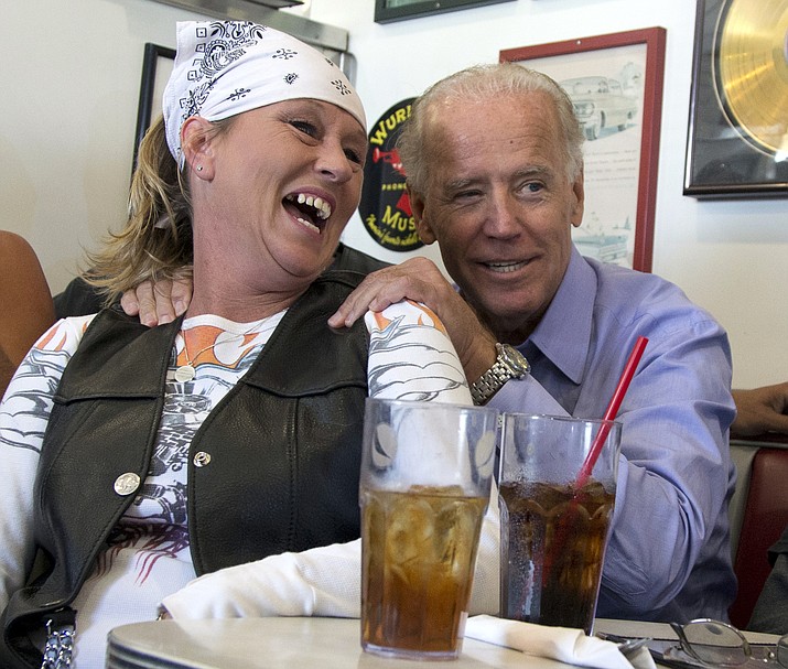 In this Sept. 9, 2012, photo, then-Vice President Joe Biden visits with patrons over lunch at Cruisers Diner in Seaman, Ohio. Biden buddied up with bikers, posed for countless pictures at a pizza place and downed an ice cream cone at a Dairy Queen over the weekend as he toured Ohio. Biden loves Ohio. (AP Photo/Carolyn Kaster, File)