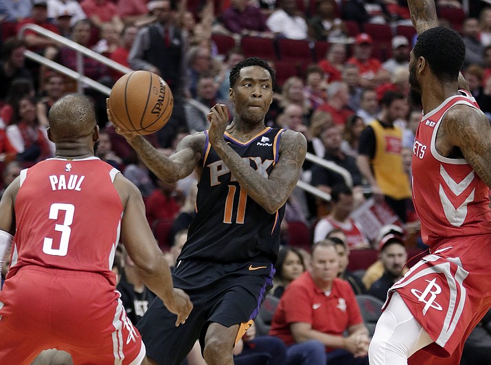 Phoenix Suns guard Jamal Crawford (11) looks to pass the ball between Houston Rockets guards Chris Paul (3) and Iman Shumpert, right, during the first half of an NBA basketball game Sunday, April 7, 2019, in Houston. (Michael Wyke/AP)