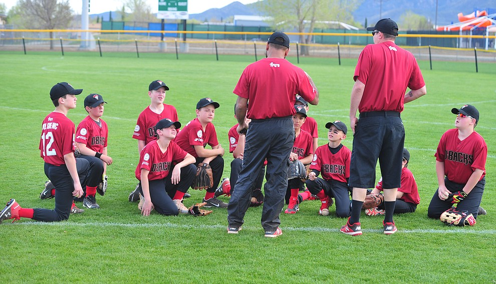 The Fry's Diamondbacks gather before the first pitch during the Prescott Valley Little League opening night Monday, April 8 at Mountain Valley Park.  (Les Stukenberg/Courier)