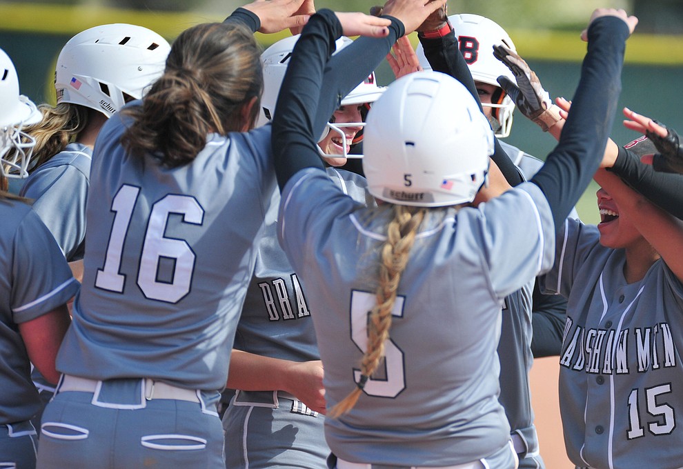 Bradshaw Mountain's Kassidy Outlaw gets congratulated by her team mates after her leadoff home run in the first inning as the Bears host the Prescott Badgers Thursday, April 11 in Prescott Valley. (Les Stukenberg/Courier)