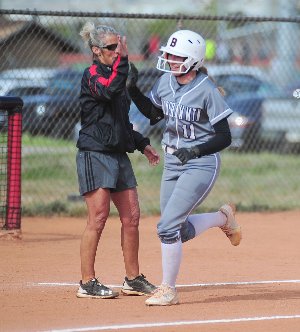 Bradshaw Mountain's Jacie Hambrick gets congratulated by head coach Sharon Haese after stroking a first inning home run as the Bears host the Prescott Badgers Thursday, April 11 in Prescott Valley. (Les Stukenberg/Courier)