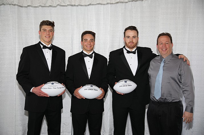 Austin Clark, from left, Colton Amos, and Garrett Fenderson with Prescott football coach Cody Collett at the National Football Foundation (NFF) Valley of the Sun Chapter Scholar Athlete honors ceremony on Saturday, April 6, in Scottsdale. Not pictured is Max Flores. (Courtesy)