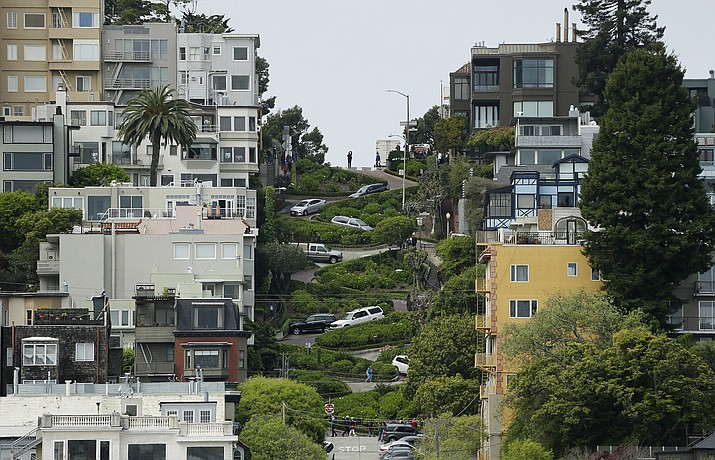 Cars wind their way down Lombard Street in San Francisco, Monday, April 15, 2019. Thousands of tourists may soon have to pay as much as $10 to drive down the world-famous crooked street if a proposal to establish a toll and reservation system becomes law. In the summer months, an estimated 6,000 people a day visit the 600-foot-long street, creating lines of cars that stretch for blocks. (AP Photo/Eric Risberg)