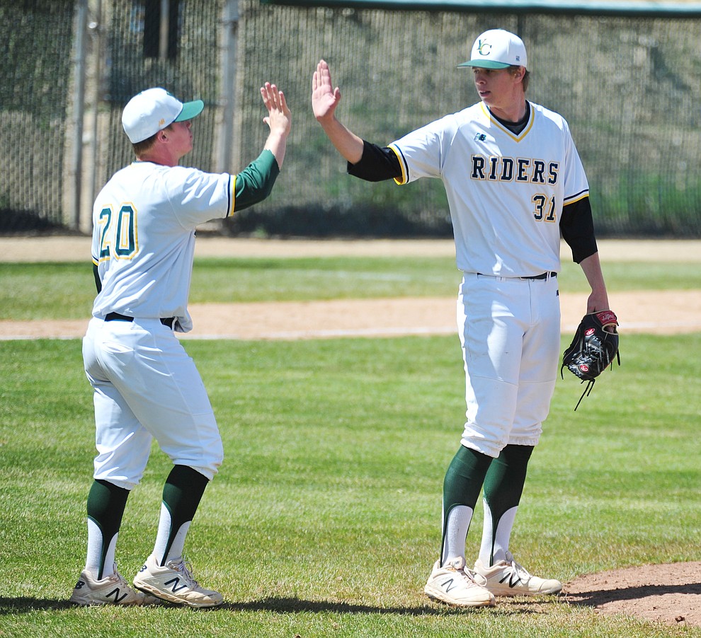 Yavapai's Sasha Sneider, left, congratulates Trey Morrill on his complete game win as the Roughriders take on Gateway Community College Wednesday, April 17 at in Prescott. (Les Stukenberg/Courier)