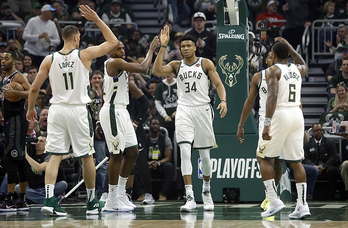 Milwaukee Bucks' Giannis Antetokounmpo gives high-fives to his teammates during the first half of Game 2 of an NBA basketball first-round playoff series against the Detroit Pistons on Wednesday, April 17, 2019, in Milwaukee. (Aaron Gash/AP)