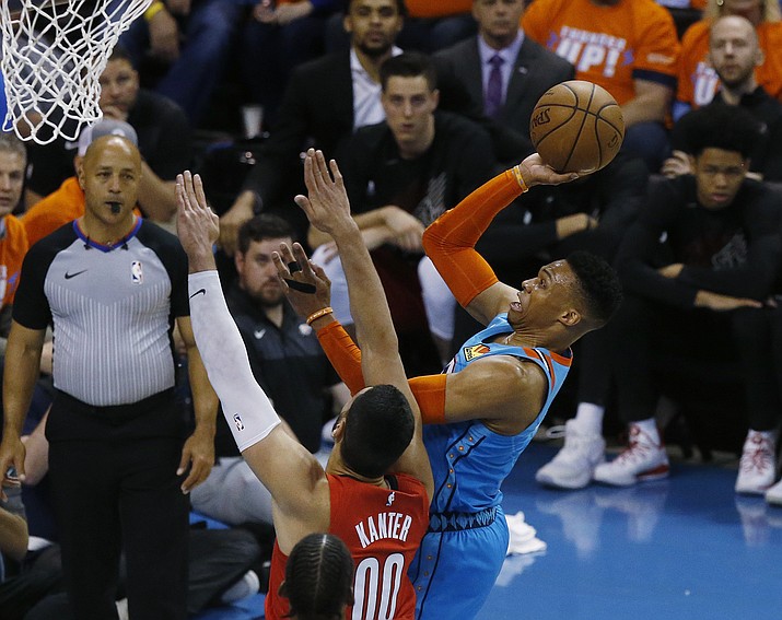 Oklahoma City Thunder guard Russell Westbrook, right, shoots in front of Portland Trail Blazers center Enes Kanter in the first half of Game 3 of their first-round playoff series Friday, April 19, 2019, in Oklahoma City. (Sue Ogrocki/AP)