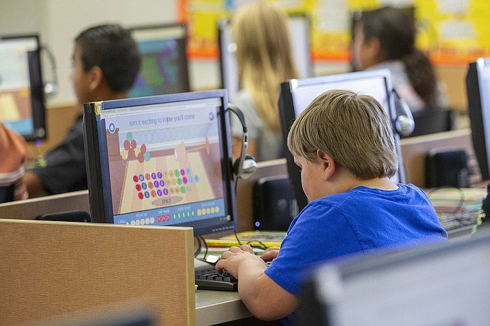Students work on computers Oct. 29, 2018, at an elementary school in Beaver, Utah. According to a study published on Tuesday, April 23, 2019, Americans are becoming increasingly sedentary, spending almost a third of their waking hours sitting down, and computer use is partly to blame. (Scott G Winterton/The Deseret News via AP)