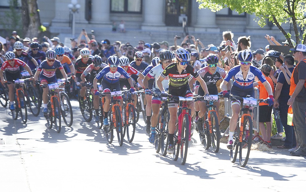 Kate Courtney and Catharine Pendrel lead the field off the first turn during the Whiskey Off Road Fat Tire Crit through the streets of downtown Prescott Friday, April 26. (Les Stukenberg/Courier)