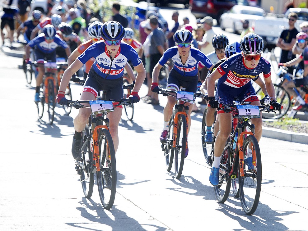 Haley Batten and Erin Huck lead the chase group up Union Street during the Whiskey Off Road Fat Tire Crit through the streets of downtown Prescott Friday, April 26. (Les Stukenberg/Courier)