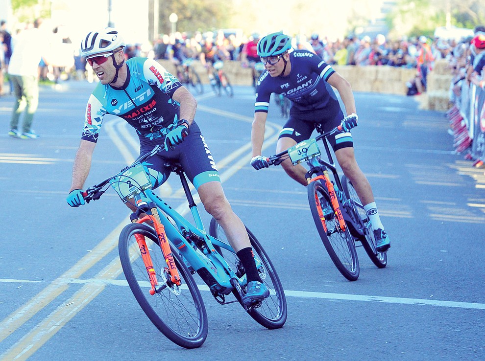 Geoff Kabush and Stephan Davoust jockey for position during the Whiskey Off Road Fat Tire Crit through the streets of downtown Prescott Friday, April 26. (Les Stukenberg/Courier)