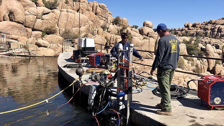 A diver with Tucson-based Arizona Commercial Diving Services comes to the surface after spending 60 minutes underwater at the Watson Lake dam.  (Cindy Barks/Courier)