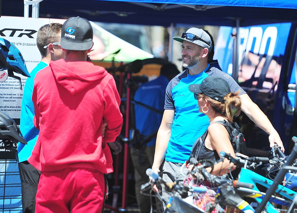 Shimano's Joe Lawwill talks to customers during the opening day of the Whiskey Off Road in downtown Prescott Friday, April 26. (Les Stukenberg/Courier)
