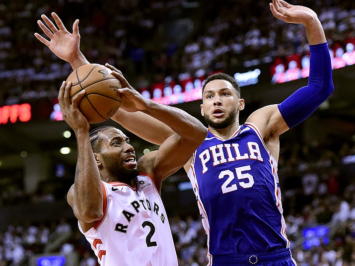 Toronto Raptors forward Kawhi Leonard looks for the shot as Philadelphia 76ers guard Ben Simmons defends during the second half of Game 1 of a second-round NBA series, in Toronto, Saturday, April 27, 2019. (Frank Gunn/The Canadian Press via AP)