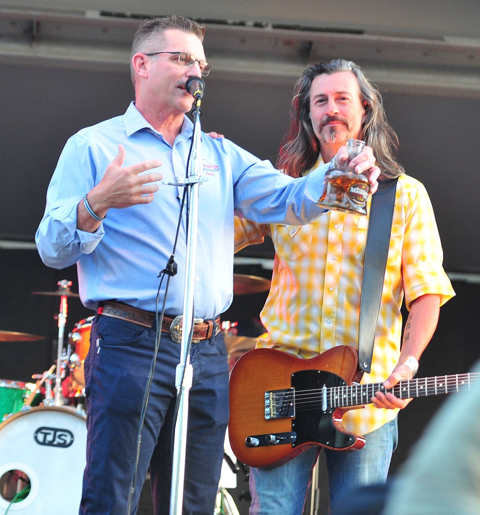 Prescott Mayor Greg Mengarelli takes a sip of Mexican Moonshine with Roger Clyne and the Peacemakers at the Whiskey Off Road in Prescott Saturday, April 27. (Les Stukenberg/Courier)