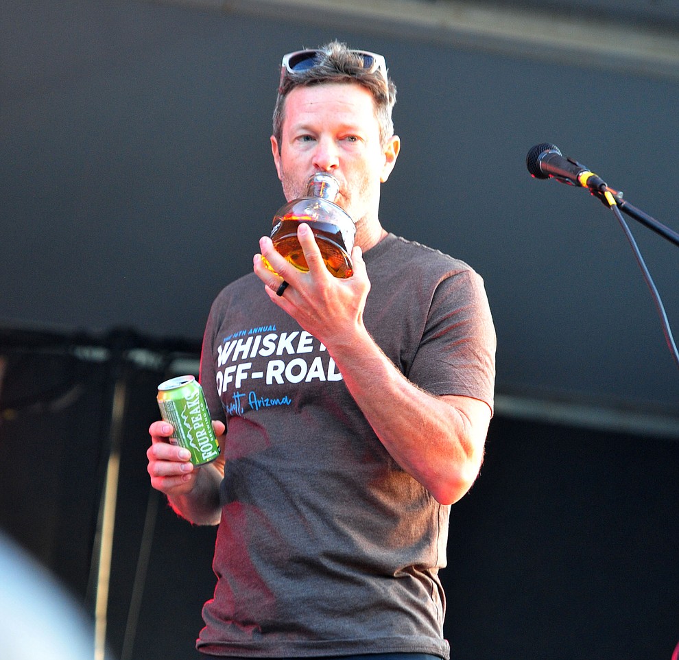 Todd Sadow takes a sip of Mexican Moonshine with Roger Clyne and the Peacemakers at the Whiskey Off Road in Prescott Saturday, April 27. (Les Stukenberg/Courier)
