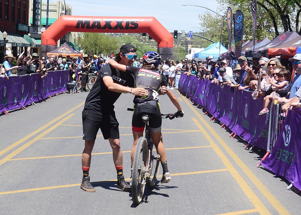 Kate Courtney gets a hug from mechanic Brad Copeland following her win at the Whiskey Off Road Pro 50-mile cross country mountain bike race in Prescott Sunday, April 28. (Les Stukenberg/Courier)