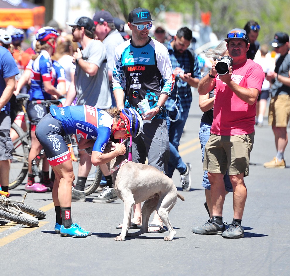 Clif Pro Team's Katarina Nash gets a little dog love, with Geoff Kabush and Kenny Wehn following the Whiskey Off Road Pro 50-mile cross country mountain bike race in Prescott Sunday, April 28. (Les Stukenberg/Courier)