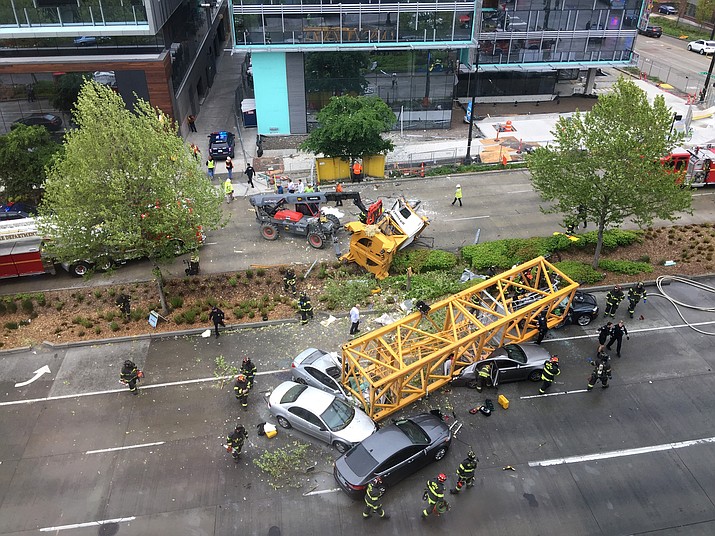 Fire and police crew members work to clear the scene where a construction crane fell from a building on Google's new Seattle campus crashing down onto one of the city's busiest streets and killing multiple people on Saturday, April 27, 2019. (Frank Kuin/AP)