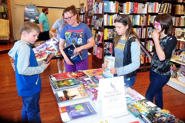 Gabe Morningstar, Katie Young, Stevi Hans and Sam Krauser check out the selection of comic books during Comic Book Day at the Peregrine Book Company in Prescott Saturday, May 4. (Les Stukenberg/Courier)