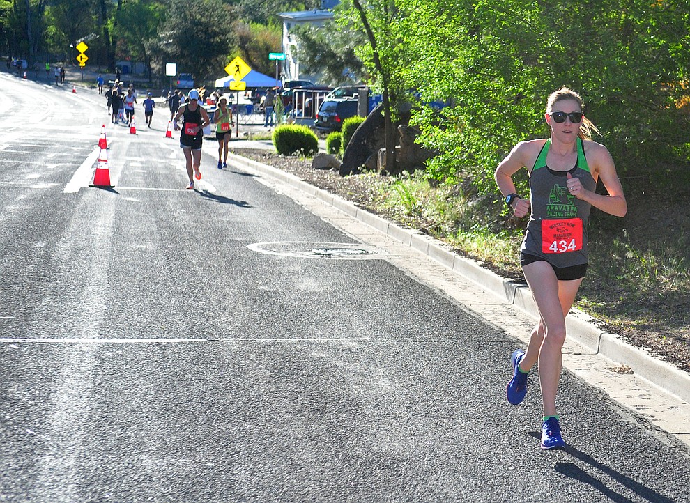 Lauren Coury and other leading half-marathon women runners head up Gurley Street during the 41st annual Whiskey Row Marathon Saturday, May 4. (Les Stukenberg/Courier)