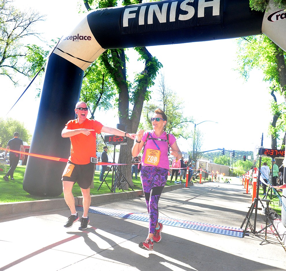 Jeff and Pamela Jones finish the 10k during the 41st annual Whiskey Row Marathon Saturday, May 4. (Les Stukenberg/Courier)