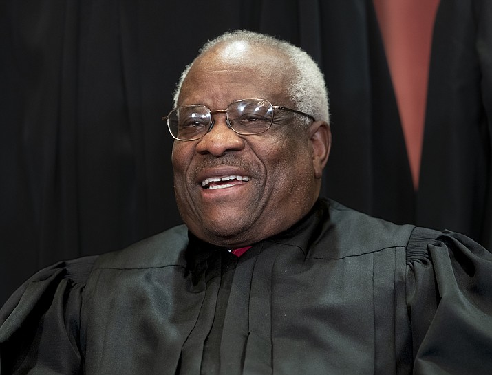 Supreme Court Associate Justice Clarence Thomas, appointed by President George H. W. Bush, sits with fellow Supreme Court justices for a group portrait Nov. 30, 2018, at the Supreme Court Building in Washington. Thomas is now the longest-serving member of a court that has recently gotten more conservative, putting him in a unique and potentially powerful position. (J. Scott Applewhite/AP, File)